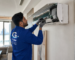 Professional AC technician repairing a split air conditioner in a modern Abu Dhabi home interior